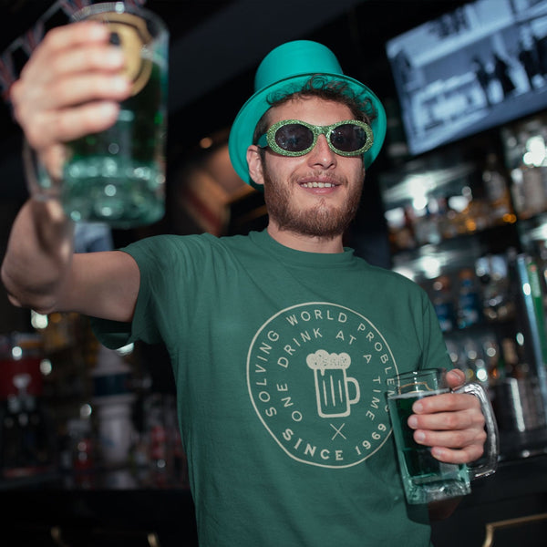 Guy wearing funny solving the worlds problems one drink at a time t-shirt from Shirty Store