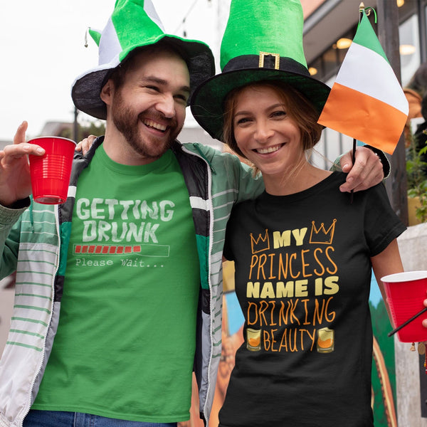 Man and woman wearing funny t-shirts celebrating St. Patrick's Day with beer and drinking